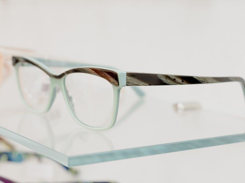 Optical lenses and frames arranged on a shelf in an optical shop