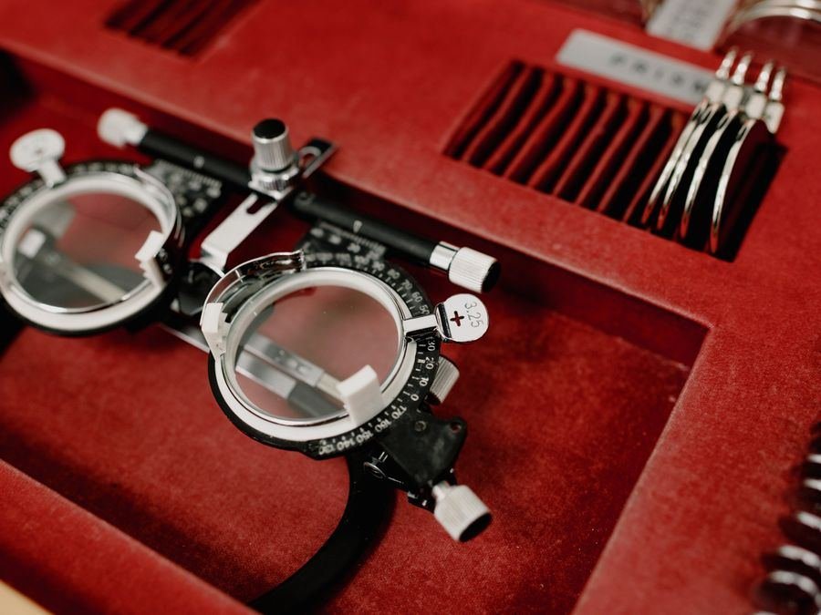 A collection of trial lenses and a trial frame used for vision testing